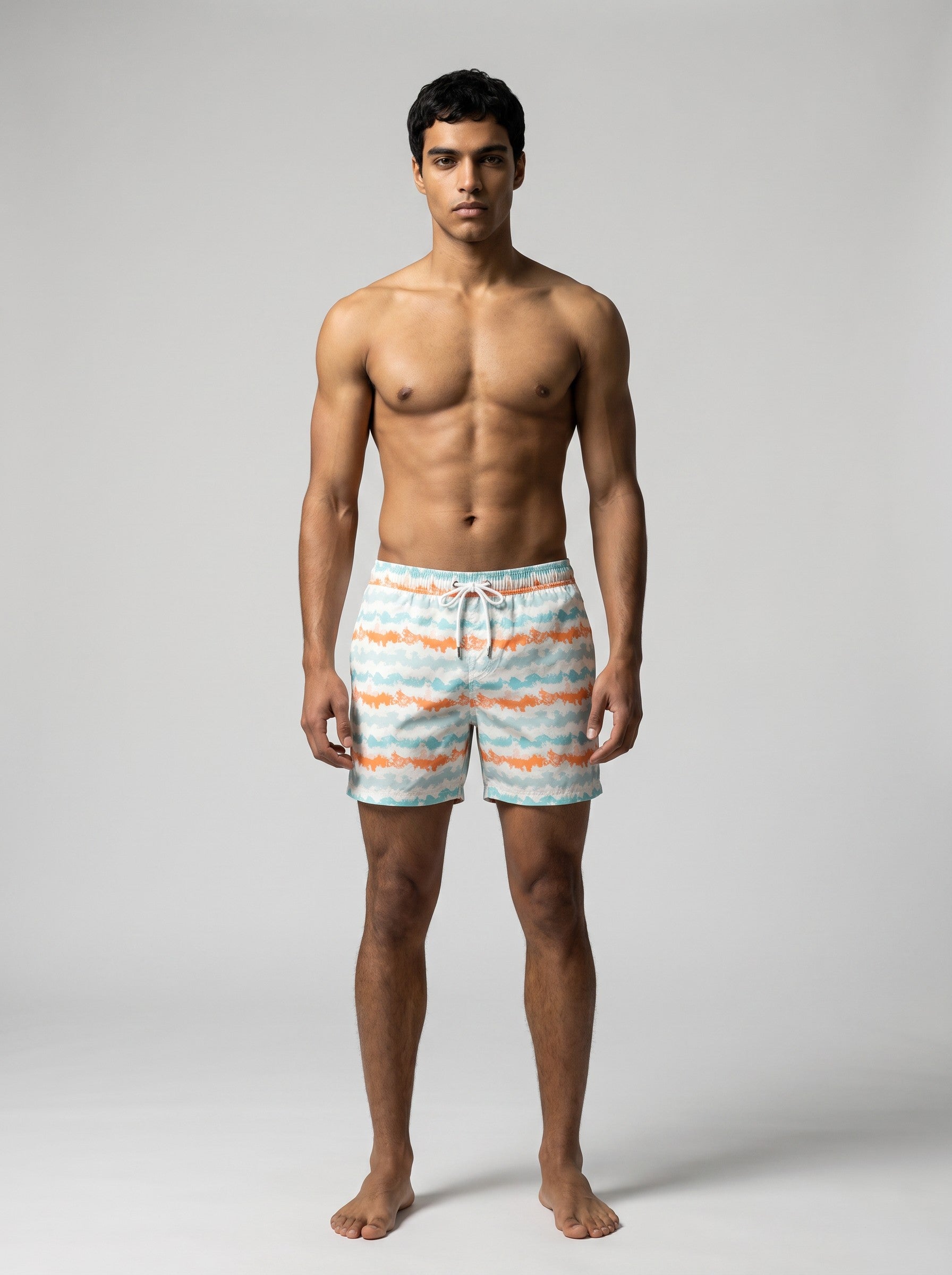 Man wearing coral and aqua Jack Rabbit Swims swim shorts